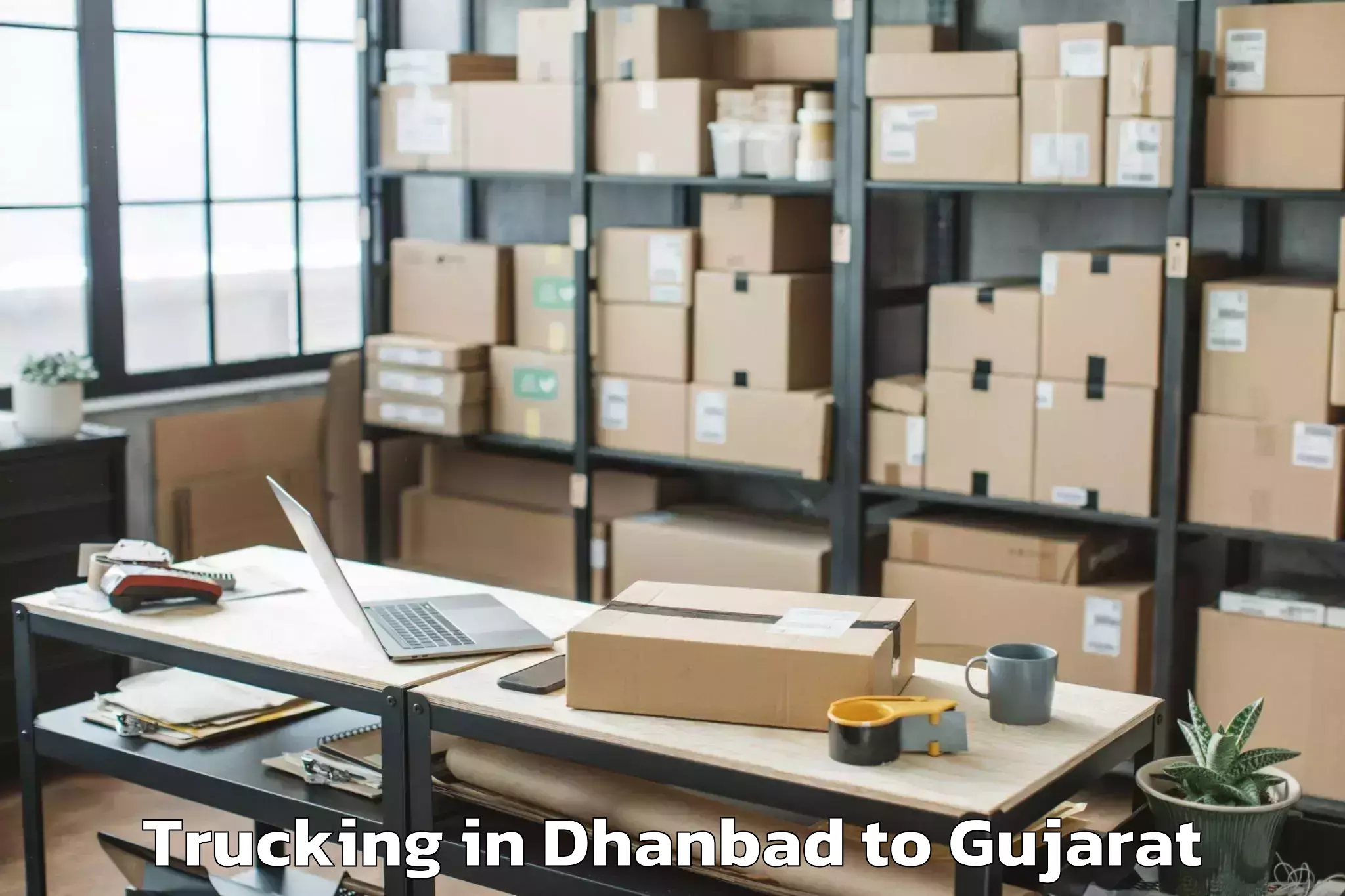 Easy Dhanbad to Rai University Ahmedabad Trucking Booking